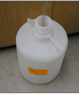 Twenty liter carboy HPLC waste container with hoses going inside.