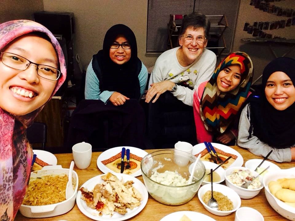 Photo caption: IFP Host, Mary McKeever enjoys ethnic dishes from around the world with her IFP partner and friends.