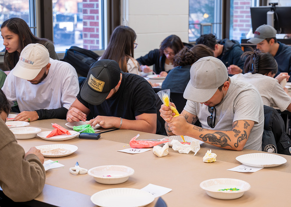 2 students decorating their sugar cookies.