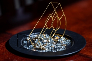 Purdue P and glass beads on a black tray