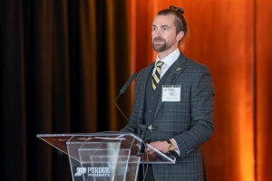 Chair of the C/P Faculty Advisory Board, Zach Weber stands at the podium