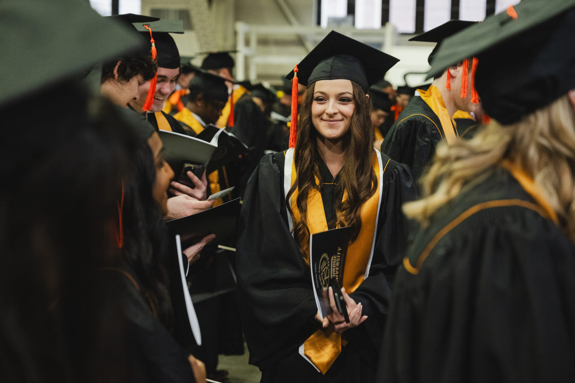 Photo of Purdue graduates in cap and gown.