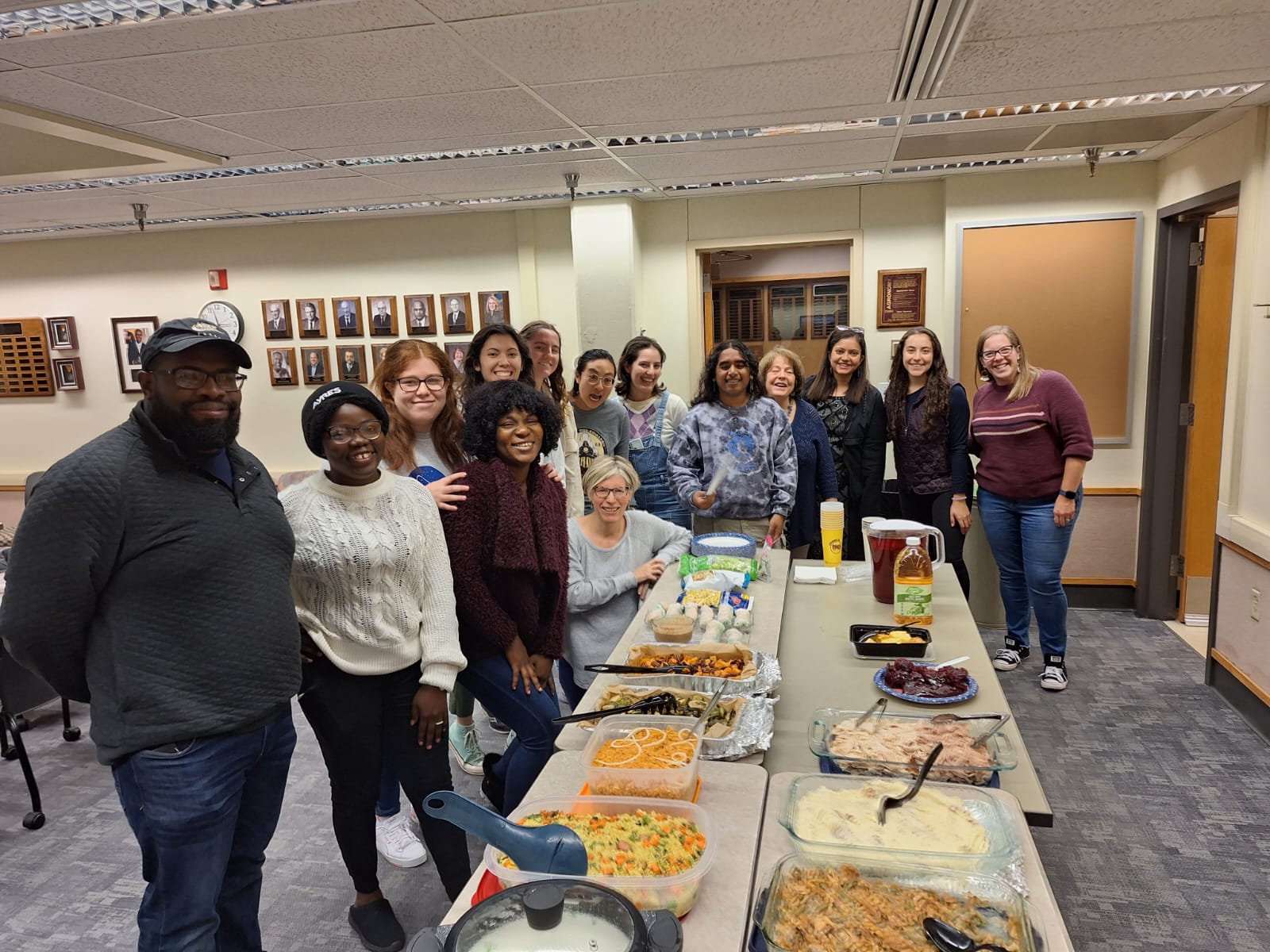 Students around a large table with food