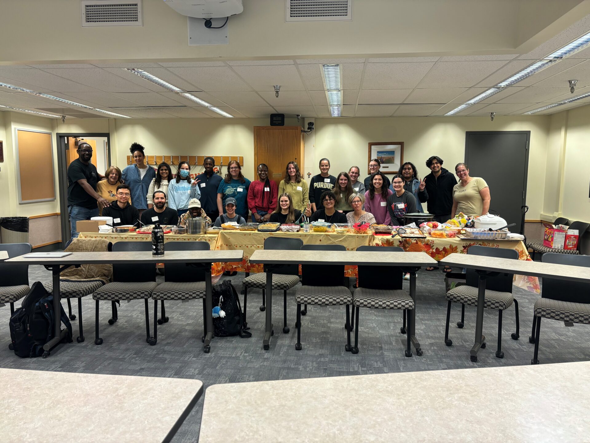 Students around a large table with food