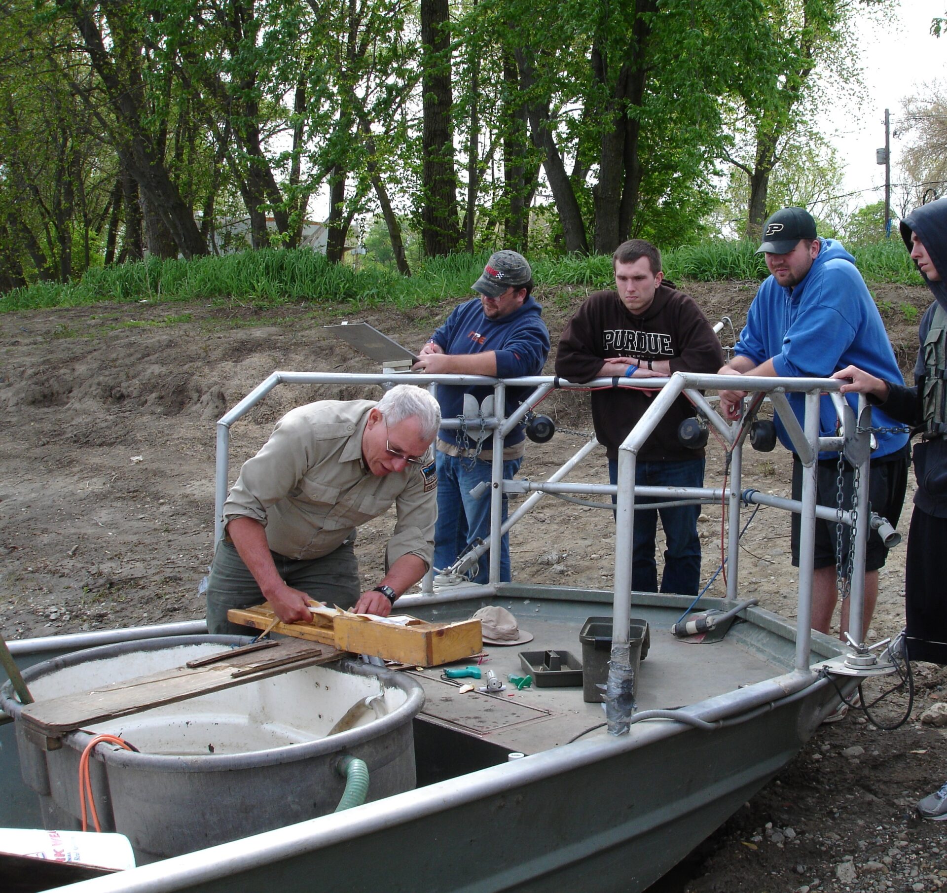 aking measurements of shovelnose sturgeon with DNR