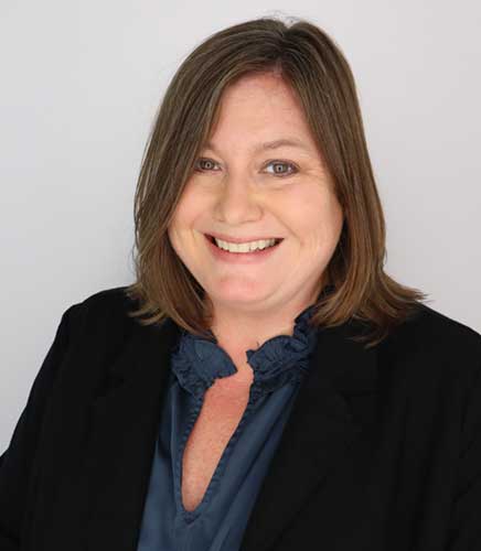 Professional headshot of a woman smiling confidently