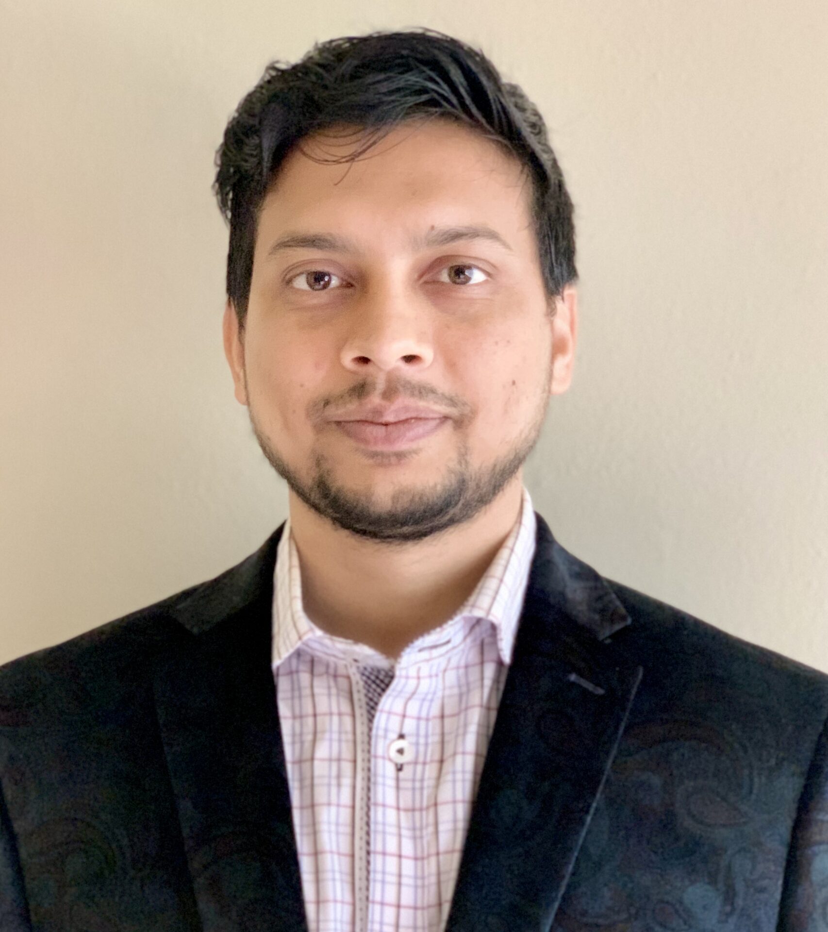 Professional headshot of a person smiling confidently