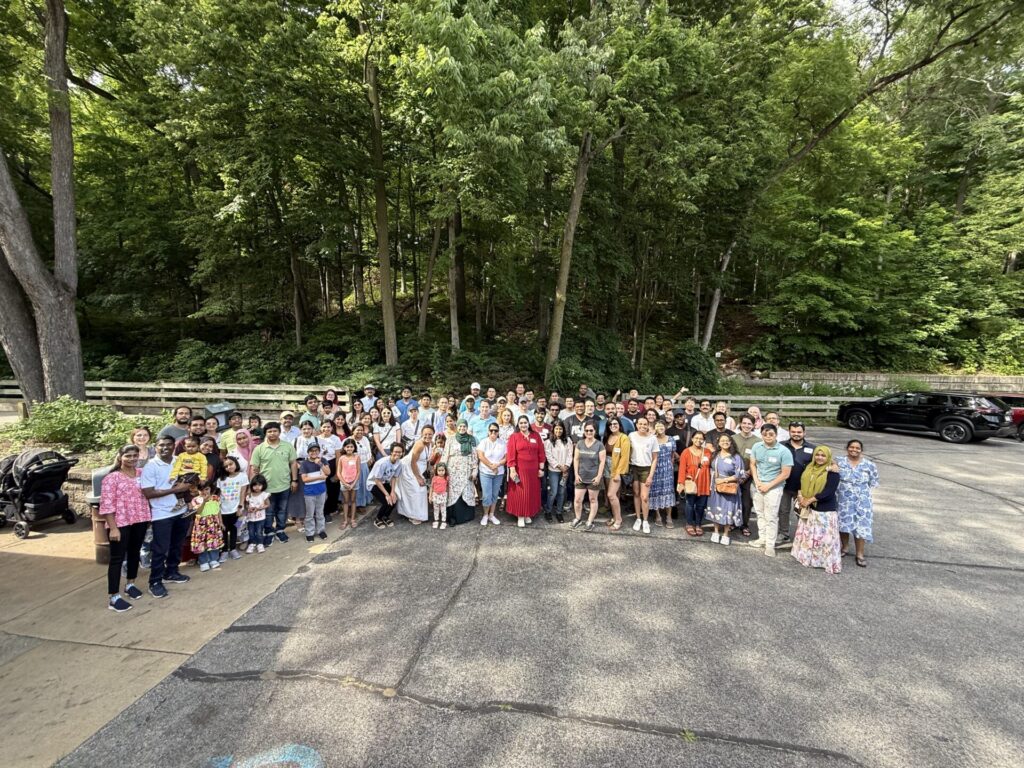 Postdoc community gathered in a park parking lot.