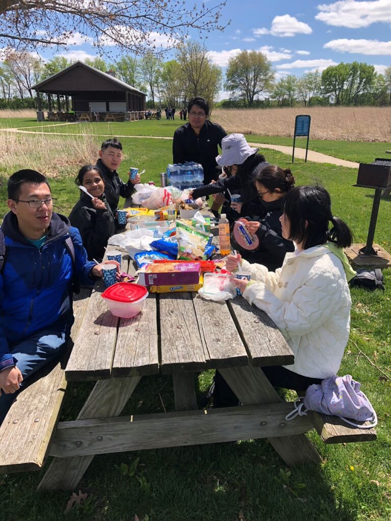 Group of postdocs eating at a park table
