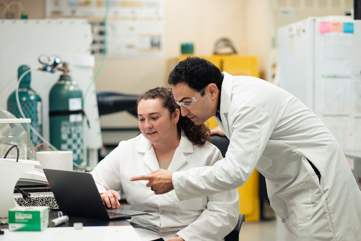 Professor mentoring a student in the lab