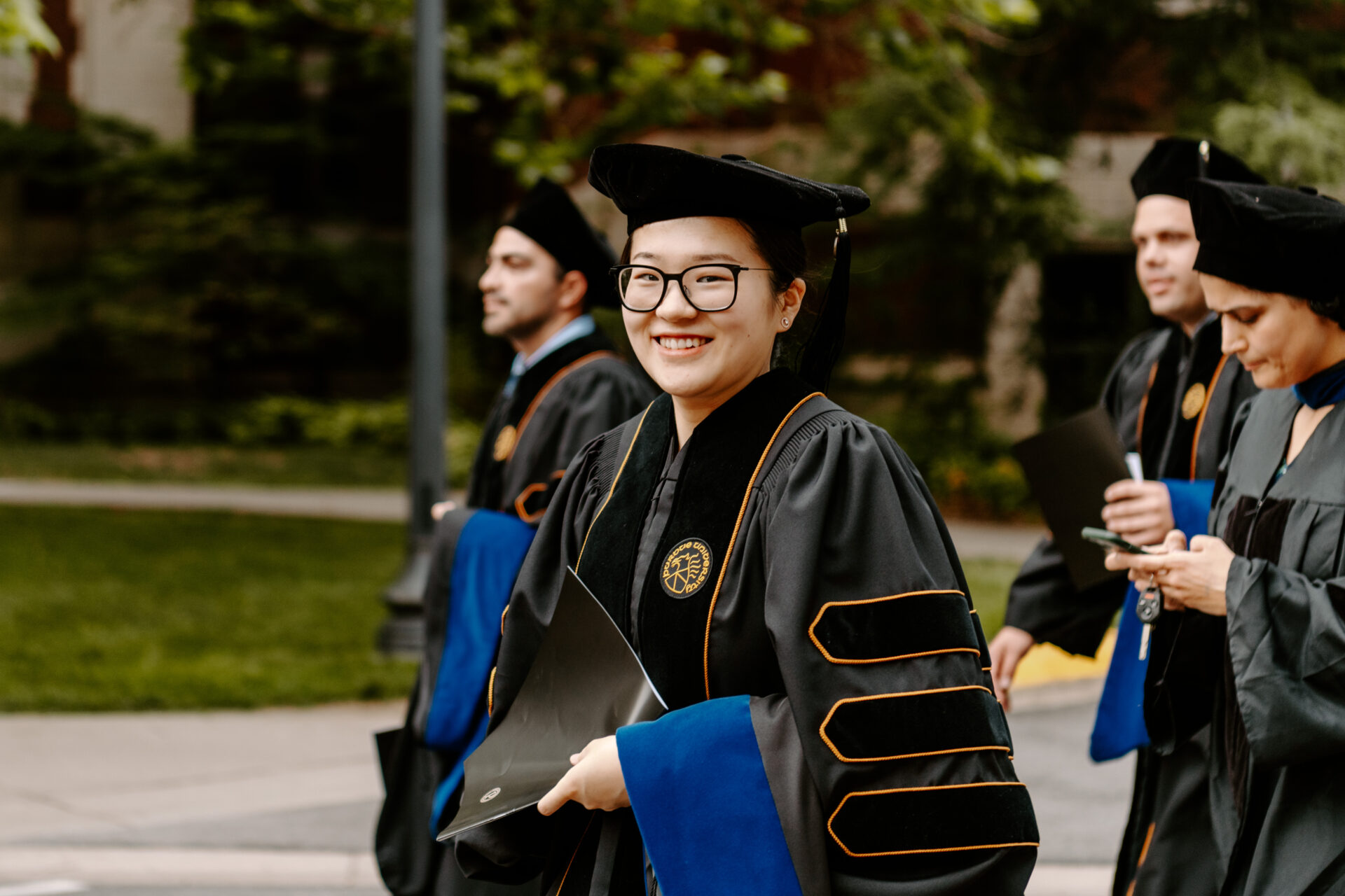 Ph.D. student in graduation cap and robes 