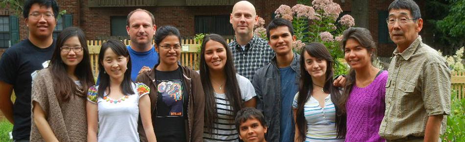 A group of people posing together in a garden 