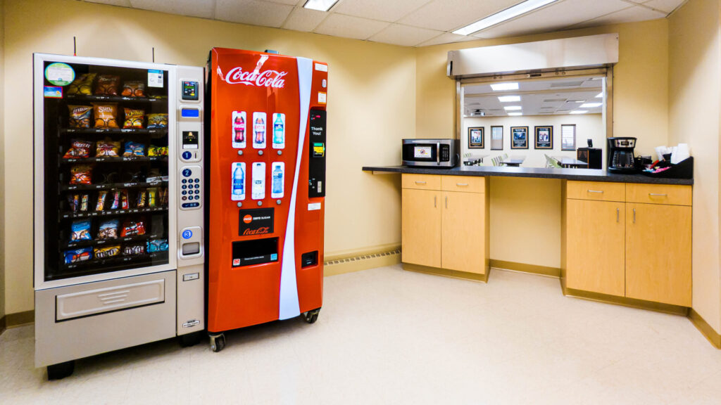 A kitchen with vending machines