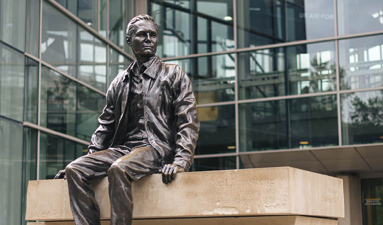 A Neil Armstrong statue in front of the Neil Armstrong Hall of Engineering.