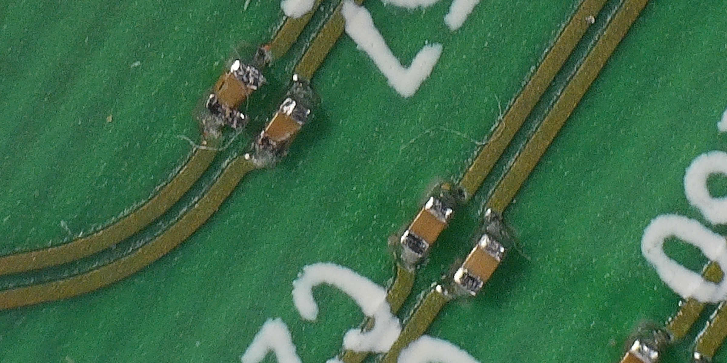 PCB with Differential Pairs showing cracked SMT DC Decoupling Capacitor before repair