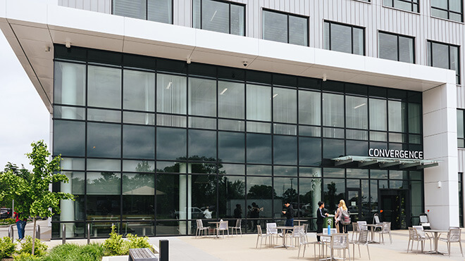 Modern glass building with an outdoor patio area