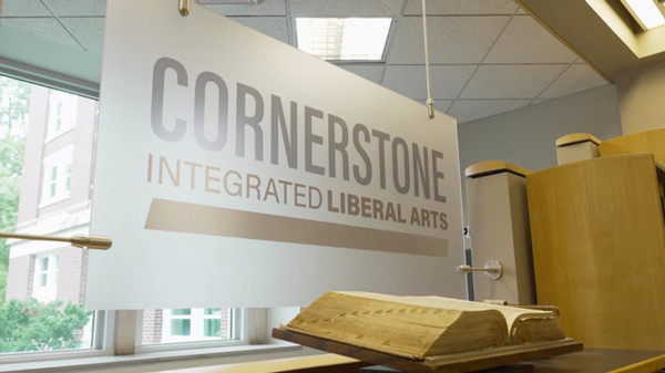 Cornerstone Integrated Liberal Arts sign with an old book