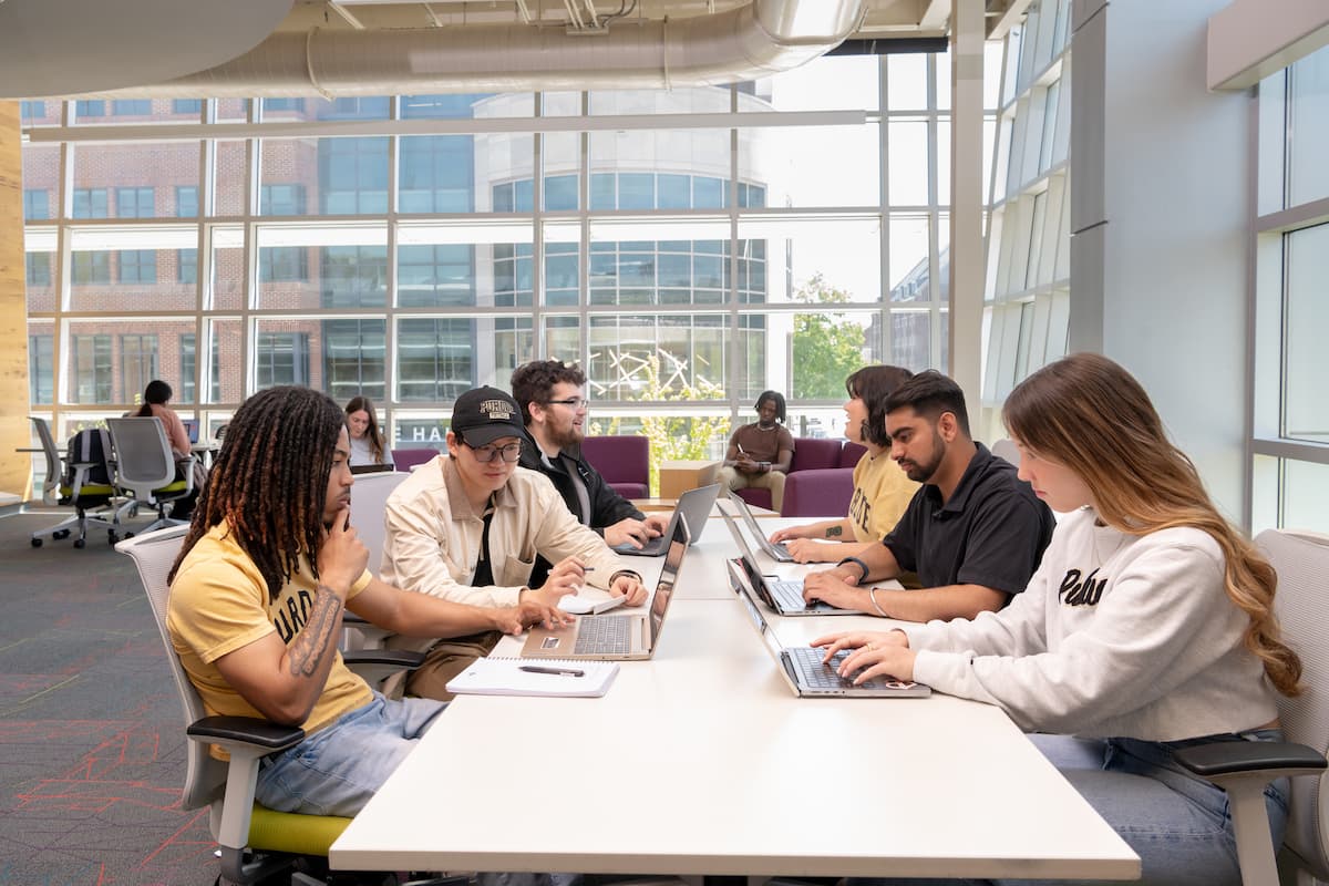 Purdue students collaborating at a modern campus study space