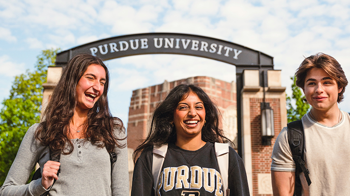 Students walking under arch on West Lafayette, Indiana campus