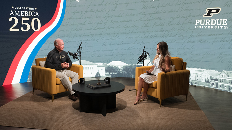 Katie Young interviewing Mitch Daniels on studio set.