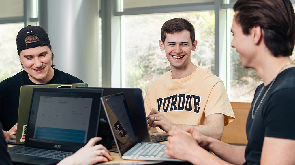 Group of students working on laptops together