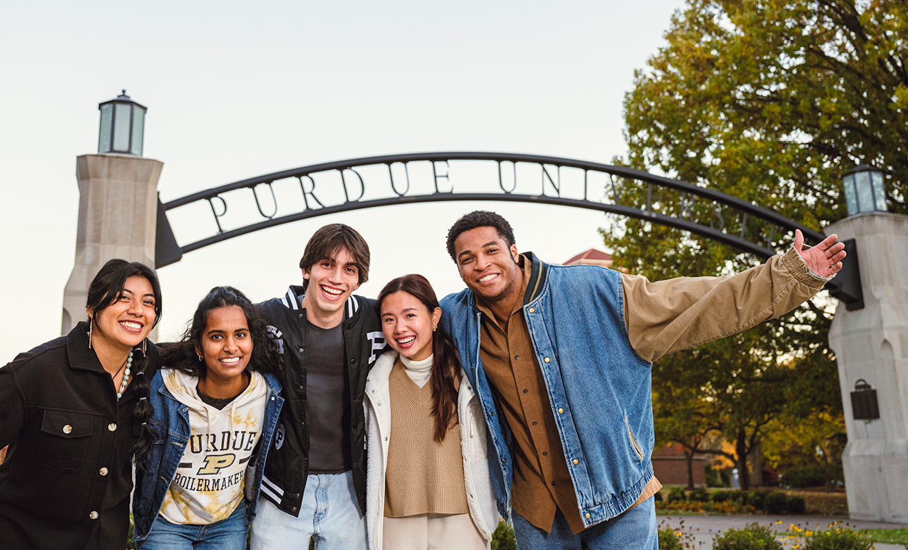 Students standing in front of Purdue University archway
