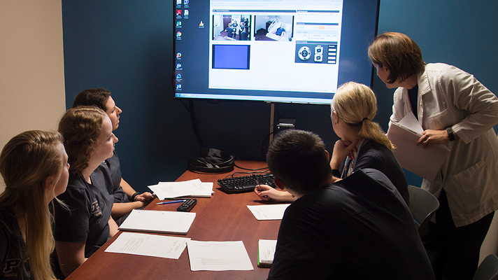Purdue nursing students reviewing medical video footage.