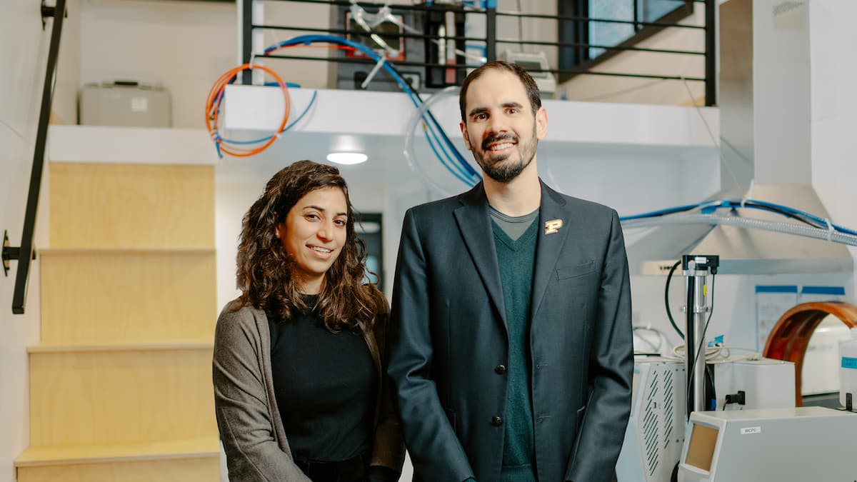 two purdue researchers posing inside a laboratory