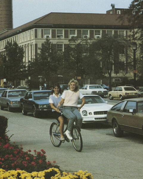 Two students riding a bike.