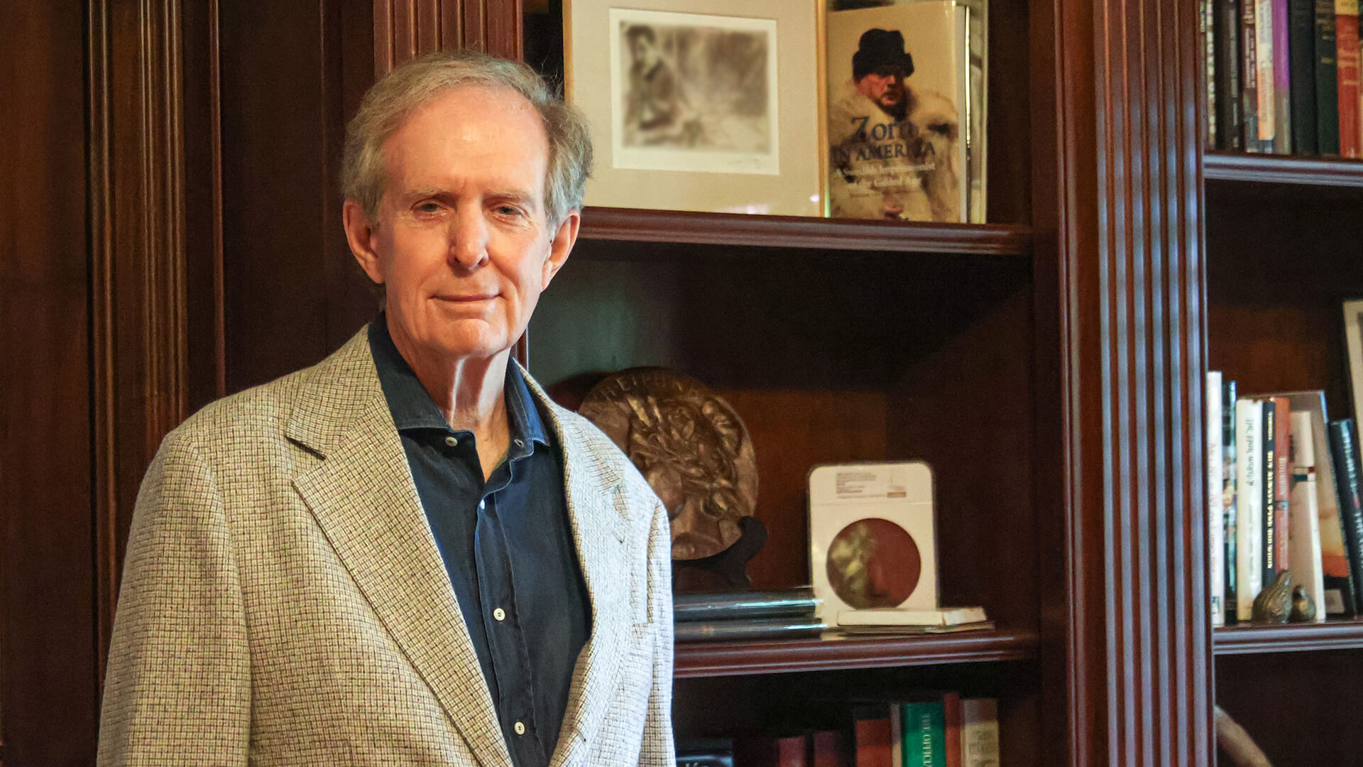 Michael Moran standing in front of bookshelves.