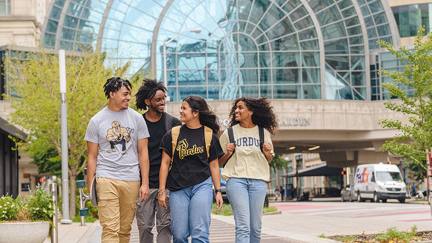 Four students walking downtown 