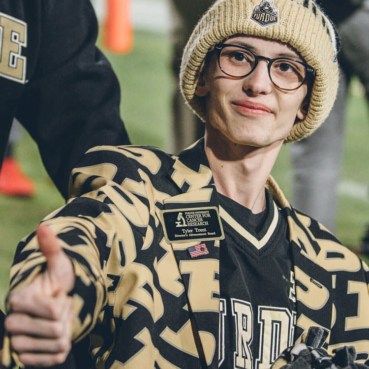 Tyler Trent giving a thumbs up from the football field