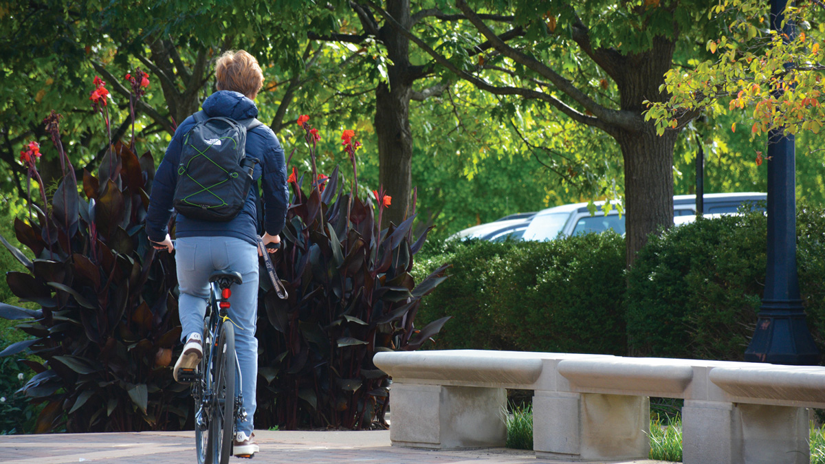 Student cycling through campus.