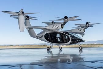 Electric vertical takeoff and landing (eVTOL) aircraft on a runway, highlighting next-generation air mobility and composite airframe technology.