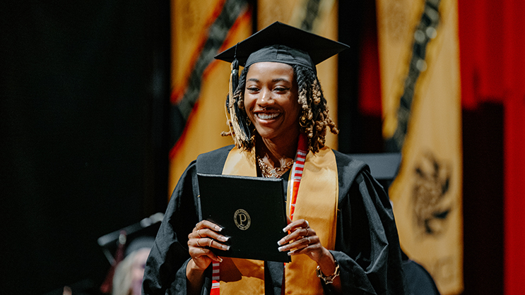 Graduate receiving diploma on stage