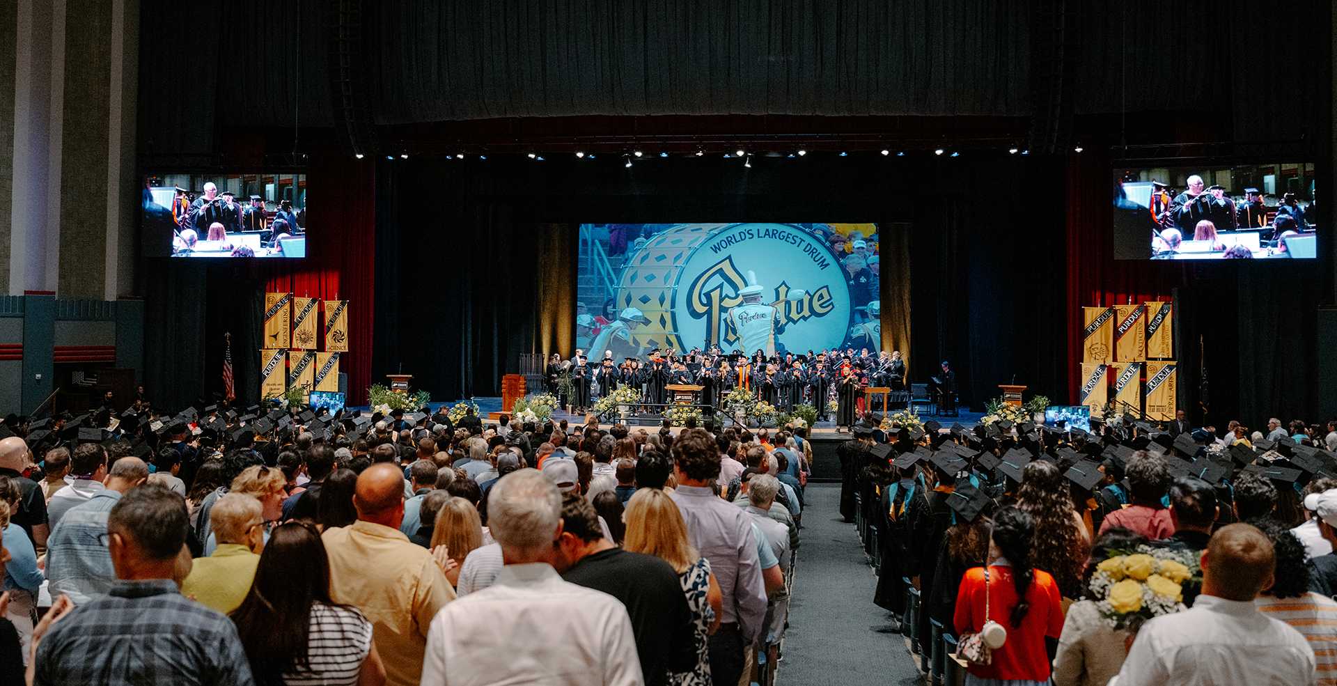 Graduates and their families watching graduation inside Elliott Hall of Music