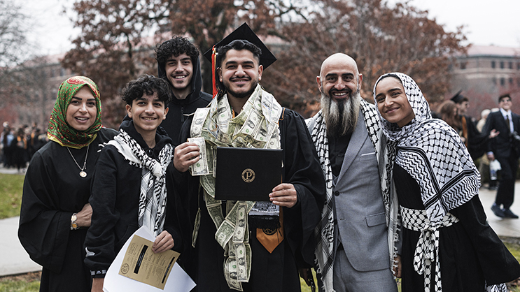 International family celebrating their graduate