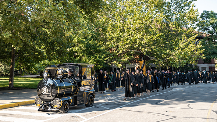 The Purdue Extra Special Train leading a procession of graduates on the way to commencement