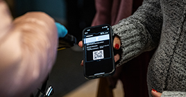Woman showing QR code ticket for entering commencement
