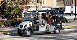 Golf cart providing accessibility for graduation attendees