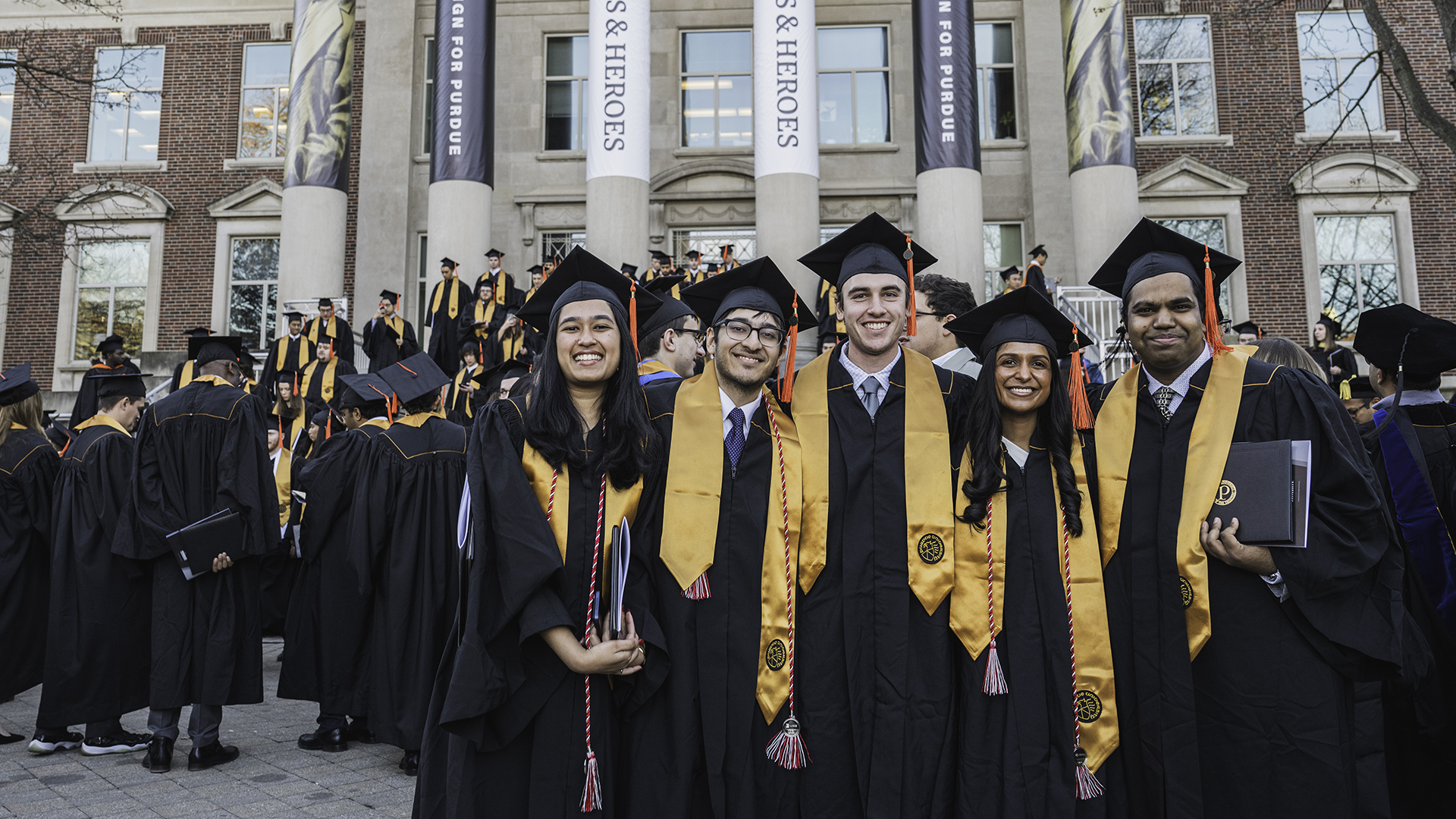 Graduates standing in front of Hovde Hall after graduation