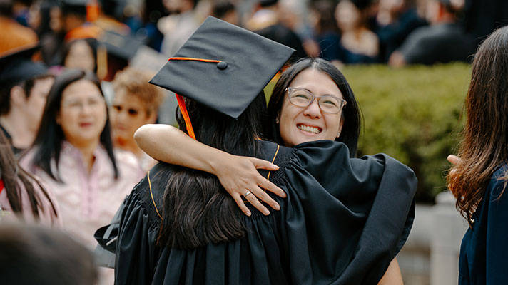Woman hugging another graduate