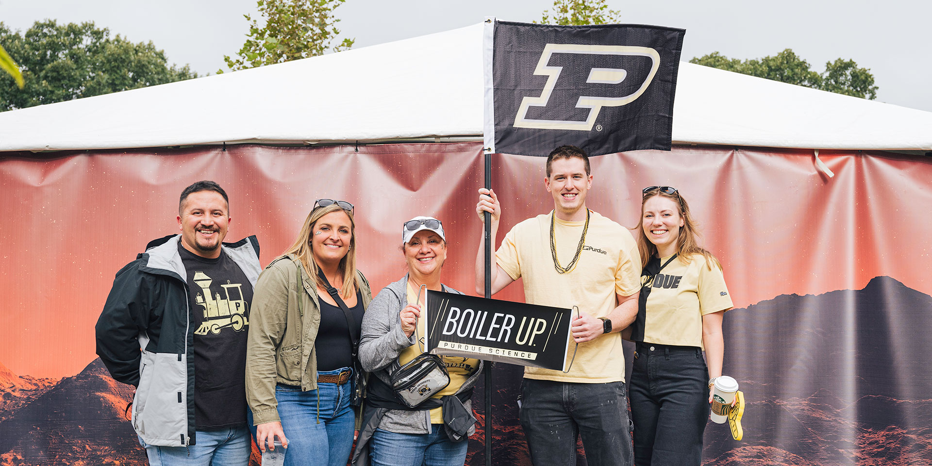 Purdue Alumni Posing for photo at Homecoming Event