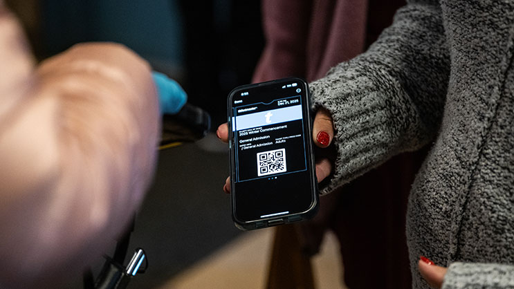 Guest of graduate scanning their ticket at Elliott Hall of Music before Purdue University commencement