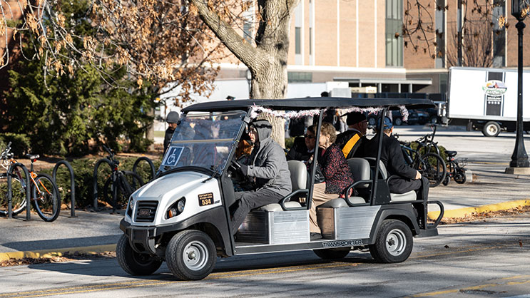 Golf cart providing accessibility for graduation attendees