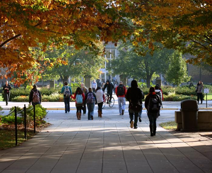 Students walk across Purdue University campus in fall.