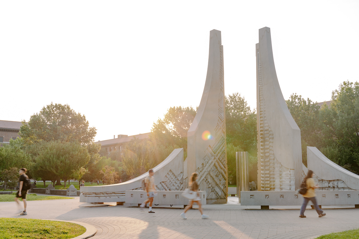 Pictured: students walk past the purdue engineering fountain on a summer day