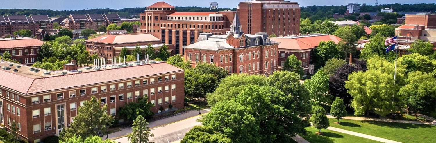 Banner picture: drone image of Purdue University, taken from above, shows trees and grass near campus center