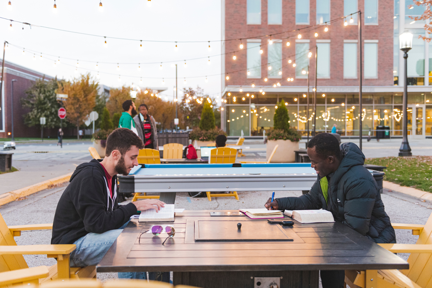 Students sit at a table outside of Krach Leaderhsip Center. Krach is home to Student Success Programs, a suite of programs which support students at various times in their Purdue journey. The DRC is a part of Student Success Programs.