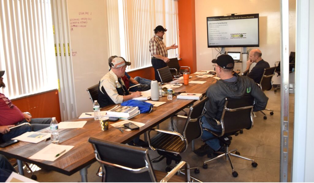 ROADS participants practicing their presentation skills before they go back to their local agency to teach CDL.